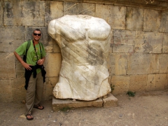 Robby stands next to a massive marble bust; Djemila
