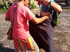 Dewa (our guide from "Bali Made Tour") helping Robby with his sarong - a requirement to visit any Hindu temple in Bali