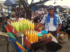 A friendly corn seller strikes a pose; Jimbaran