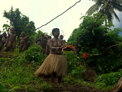 Village woman cheering on her son, the youngest land diver to jump today