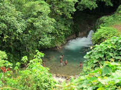 Village kids playing in a lower pool of the waterfall