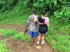 Michael helping Tanya down a slippery path - she wasn't too keen about the machete in his left hand as he kept slipping himself!