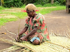 Village elder weaving floor mats