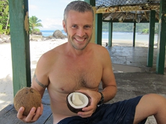 Cracking coconut shells for a snack; 2 Dollar Beach