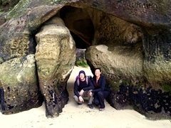 Posing beneath a natural archway; Anchorage Beach