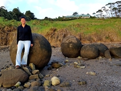 Becky striking a pose at Koutu boulders, the obscure spherical boulders of the north island