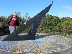 Robby stands by a large mosaic sundial on Flagstaff Hill; Russell