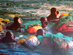 Photograph of "haenyeo", female divers from Jeju famous for gathering shellfish, abalone and sea urchins; Seongeup Folk Village