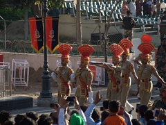 A detail of soldiers marches the flag back to signal the end of the Wagah Border Ceremony