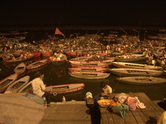 Spectators watch the aarti from the Ganges River