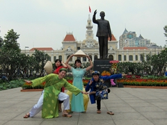 Locals striking a pose by Ho Chi Minh's statue; Saigon
