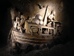 A carving depicting river barge travel to transport wine and people at Les Caves Bailly Lapierre