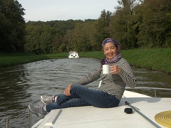 Mom soaking up the sun with a cup of coffee...life is so tough on the Canal du Nivernais!