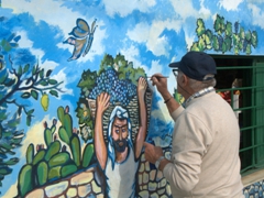 Painter working on a mural; Corniglia