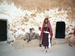 Becky dressed in a Berber traditional outfit at our Matmata underground troglodyte hotel as Ryan and MAJ Keith look on