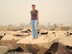 Becky atop an abandoned T-72; Balad MiG-23 graveyard