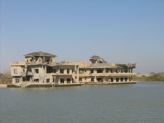 Partially demolished buildings on "lost lake"; Camp Victory