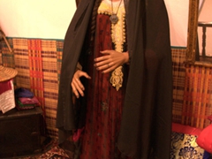 A woman modeling a "burqa", which in the UAE refers to the face covering that is painted or dyed gold and rubbed until shiny; Ajman Museum