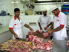 Butchers chopping up goat heads; Dubai