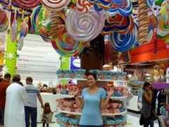 Becky stands beneath a whimsically fantastic lollipop tree; Dubai Mall