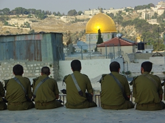 Israeli soldiers soak up the ambience of Jerusalem from a rooftop in the Armenian Quarter
