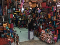 A lady ponders which leather shoes to buy