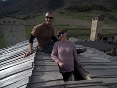 Robby and Sofi next to Svan towers in Mestia
