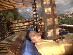 Ann, Becky and Robby relax in our robes on a shaded terrace after about 10 minutes of sweating in the steam boxes; Piedra de Agua Fuente Termal & Spa, Cuenca