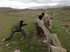 The boys peer through holes in the massive rocks of this ancient astronomical observatory; Zorats Karer