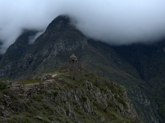 Shrouded in clouds, a watch tower at the base of Tatev monastery
