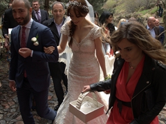 A beautiful bride hikes up to Geghard Monastery. Luckily, the rain stopped just a few minutes before her visit