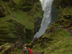 Robby strikes a pose next to one of the many waterfalls on the Fimmvörðuháls hike

