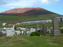 Eldfell Volcano looms over the island's cemetery; Westman Islands