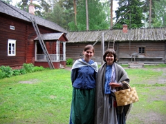 Two smiling Finnish guides dressed in traditional costume. During the summer months, they showcase folk-dancing and crafts at the Seurasaari Open Air Museum