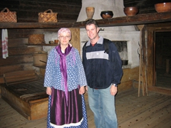 A Finnish guide dressed in traditional costume poses with Robby at the Seurasaari Open Air Museum
