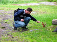 Robby feeding a tame squirrel, Helsinki open air museum