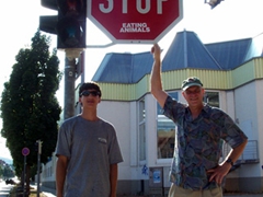 Luke and Bob stand under a "STOP EATING ANIMALS" sign in Feuerbach