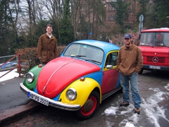 Jim and Robby strike a pose next to a colorful VW bug