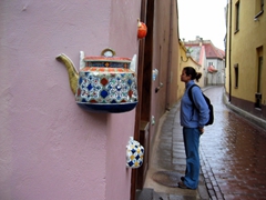 Becky checking out tea pots embedded in the wall; Vilnius