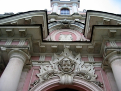 Detail on the portal of the pink, baroque church of St Casimir